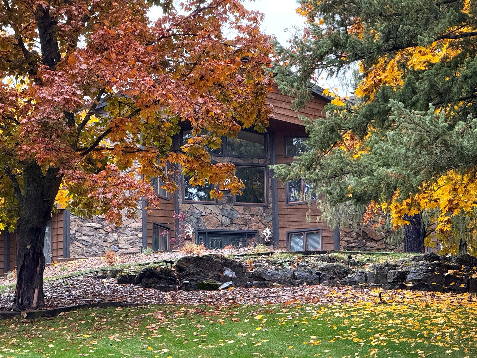 Eagle's Bluff main house surrounded by fall colors on Flathead Lake